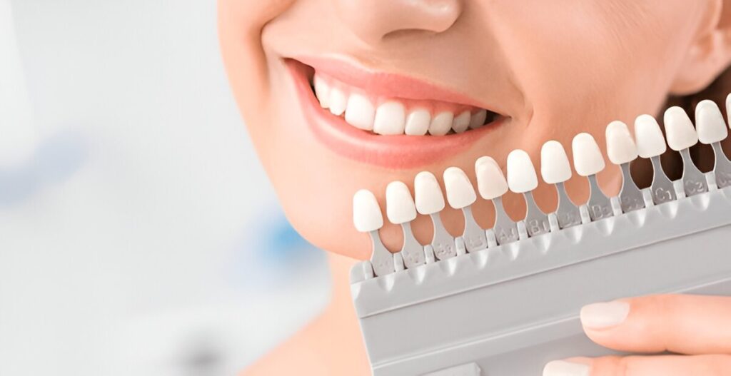 Patient comparing tooth shades for dental crown treatment in Sherwood Park