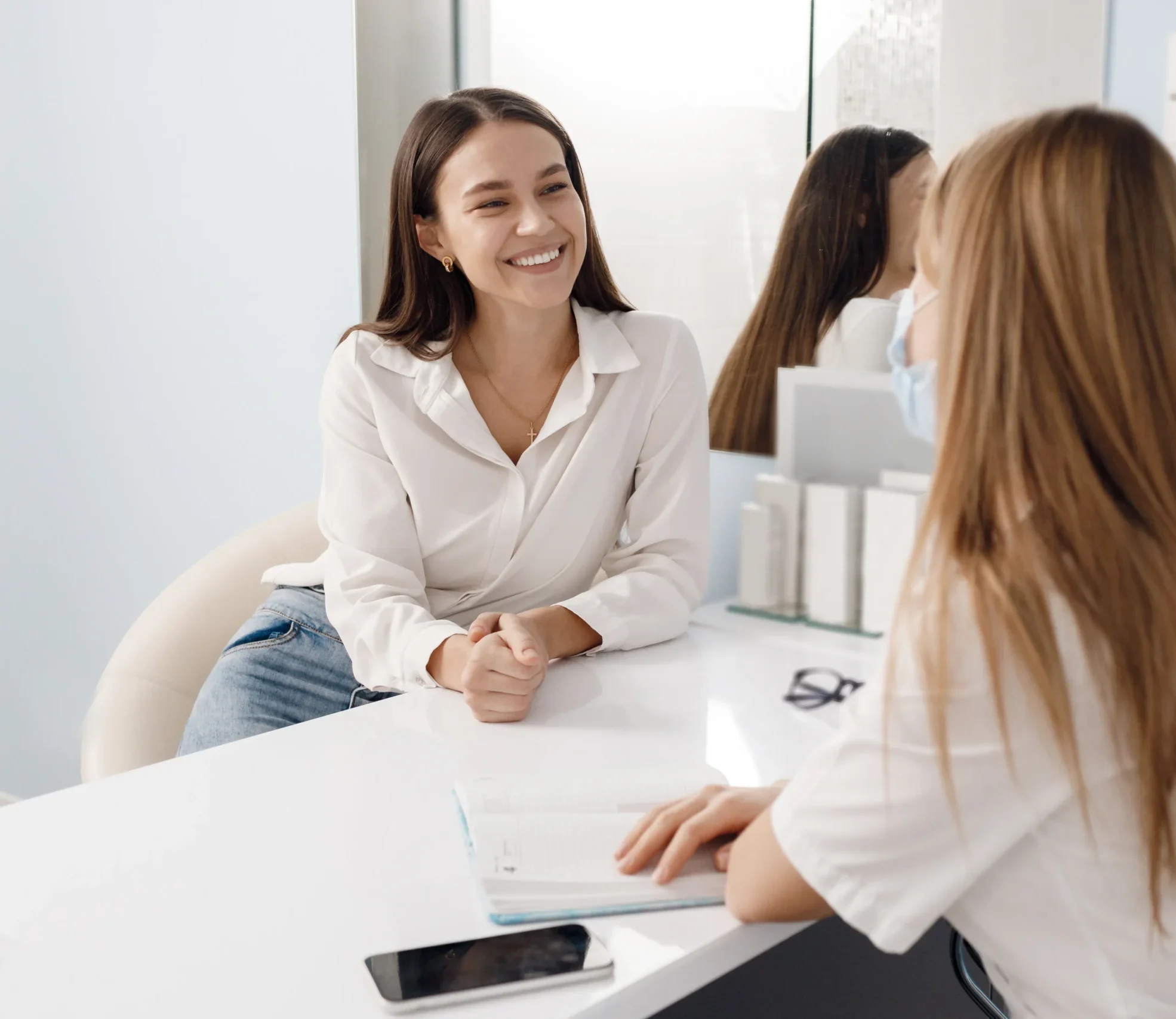 Dental clinic staff helping a patient understand insurance paperwork and billing information in a calm office setting.