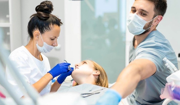 Adult patient discussing professional fluoride treatment with a friendly dentist during a preventive dental exam at Granada Dental.