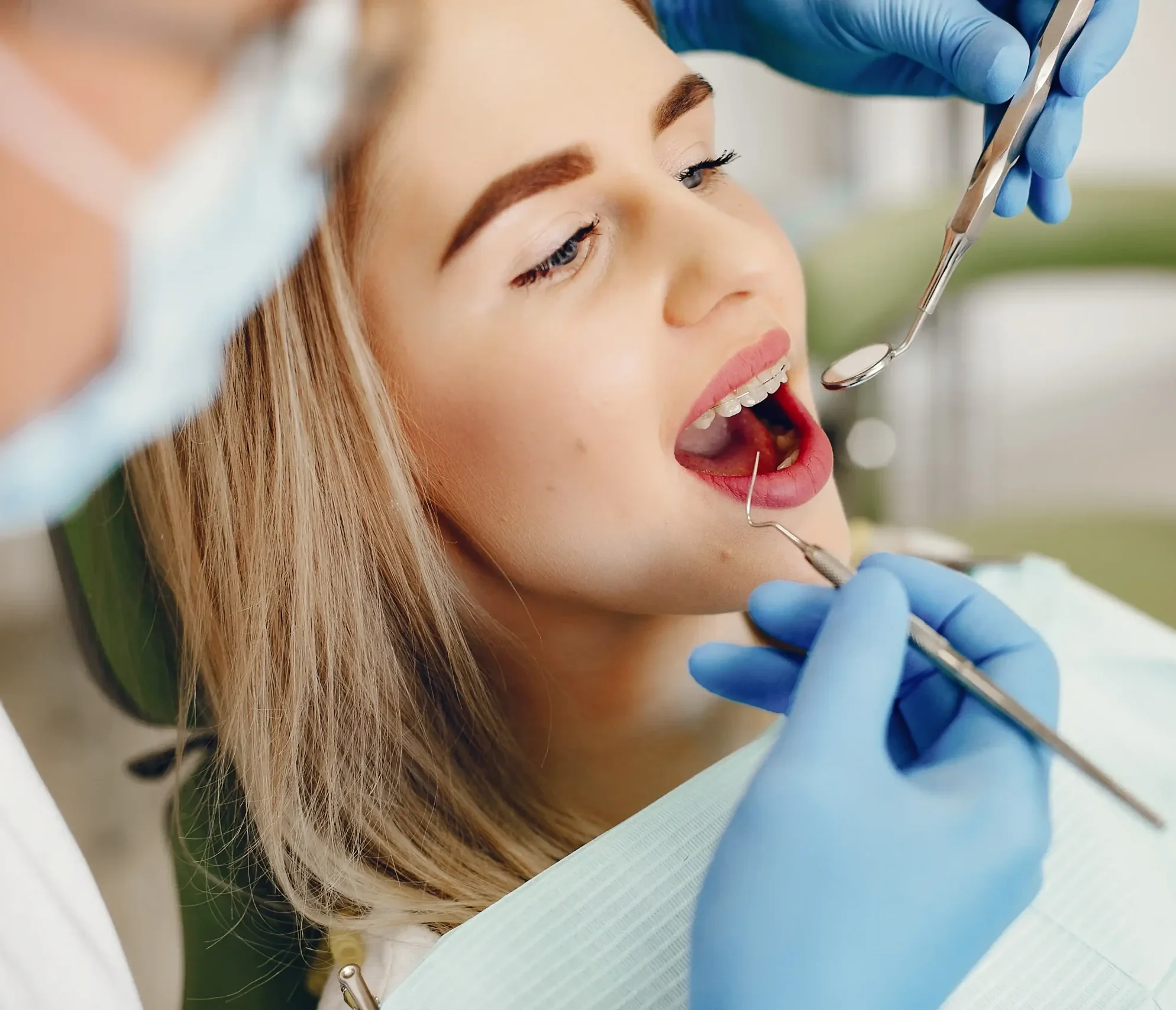 Dentist reviewing an X-ray to determine whether a damaged tooth can be saved